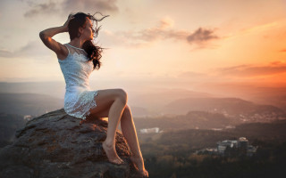 Woman rock wind sunset city - a city in the distance free wallpaper