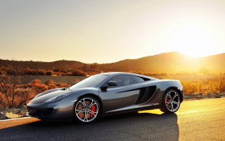 Silver sports car mountain sunset - a road near a mountain range free wallpaper