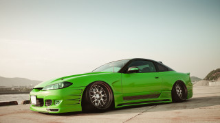Green sports car water mountains - a green sports car free wallpaper