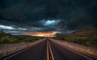 Stormy road cityscape clouds horizon - a dark sky in the background free wallpaper