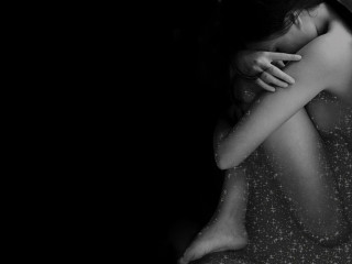 Woman hugging head dark room - her free wallpaper