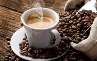 Coffee saucer beans wooden table - a pile of coffee beans free wallpaper