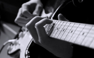 Person playing guitar fingers neck - a guitar free wallpaper