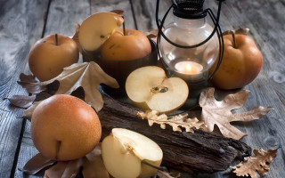 Candle apples leaves wooden table - autumn free wallpaper