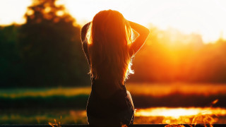 Woman lake sunset backlighting autumn - her hand behind her head free wallpaper
