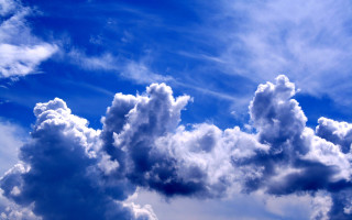Plane clouds blue sky mountains - a plane in the distance free wallpaper