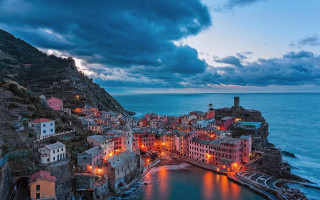 Cliffside town ocean night city - evgeny lushpin free wallpaper