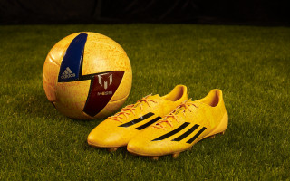 Soccer ball yellow shoes green - a green grass field free wallpaper