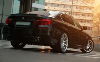 Black car city street tall 2 - a black car free wallpaper