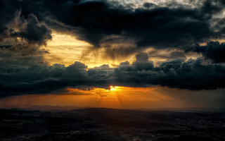 Sunset dark cloud sunshine valley 2 - a bright sun in the distance free wallpaper