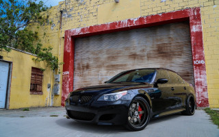 Black car garage red door 2 - a yellow wall behind free wallpaper
