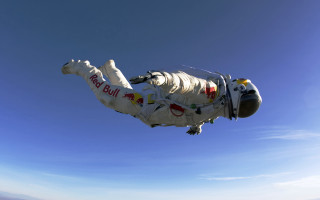 Space man parachute blue sky - a photo free wallpaper