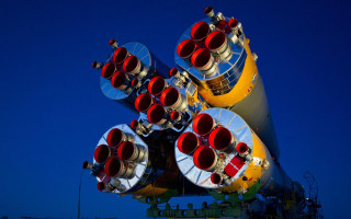 Large rocket red yellow rocket - a blue sky in the background free wallpaper for desktop