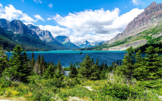 Scenic lake mountains trees boat 2 - a scenic view of a lake free wallpaper