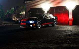 Black car red garage night - a black car free wallpaper
