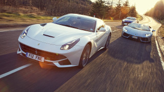 Two white sports cars driving - tree and a forest in the background free wallpaper