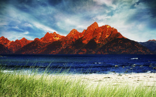 Mountain range lake boat sky - the foreground and a boat in the distance free wallpaper