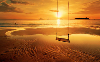 Beach sunset swing water mountains - a person in the background free wallpaper