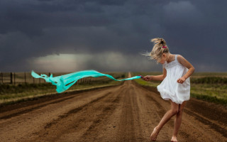 Girl white dress running blue - a dark sky in the background free wallpaper