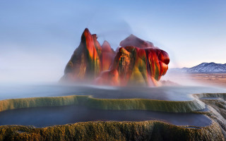 Large rock formation mountain lake - a mountain in the background and a body of water free wallpaper