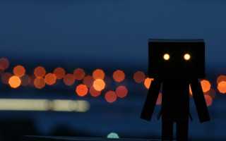 Toy robot figure glowing eyes - a toy figure free wallpaper