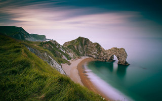 Beach rock formation water landscape - a rock formation in the middle of it free wallpaper