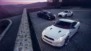 Three sports cars mountain sunset 2 - a road near a mountain range free wallpaper