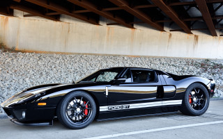 Black sports car bridge rocks - glossy free wallpaper