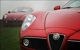 Red sports cars foggy field - a black car in the foreground free wallpaper