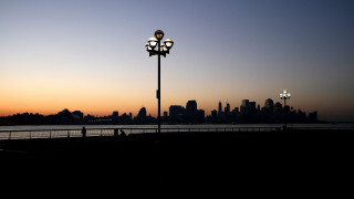 Streetlight water sunset city silhouette - a city in the background free wallpaper