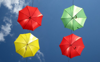 Three umbrellas clouds sky colorful - triadic free wallpaper