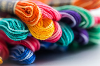 Yarn closeup table spool thread - a close up of a bunch free wallpaper