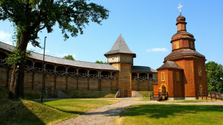 Large wooden building clock tower - a grassy field free wallpaper