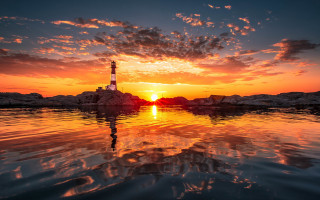 Lighthouse sunset reflection beach water - a reflection of the sky free wallpaper
