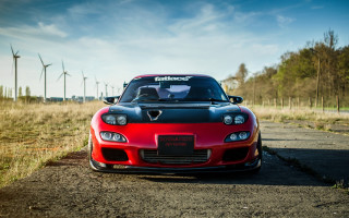 Red sports car windmills blue - a dirt road next free wallpaper