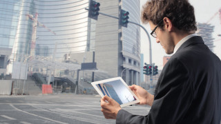 Man suit holding tablet city - a city street free wallpaper