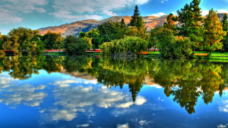 Lake mountains trees cloudy sky 20 - tree and mountains under a cloudy sky free wallpaper