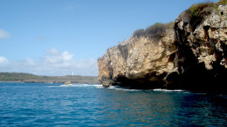 Rocky cliff lighthouse ocean boat - the top of it free wallpaper