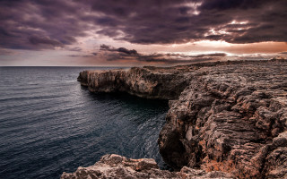Rocky cliff water cloudy sky 2 - a few cloud above free wallpaper