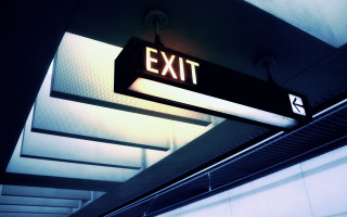 Exit sign hanging hallway institutional - diffuse free wallpaper