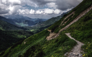 Grassy hill mountains clouds nature - a grassy hill free wallpaper