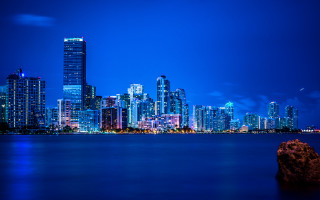 City skyline night water rock 2 - a rock in the foreground free wallpaper