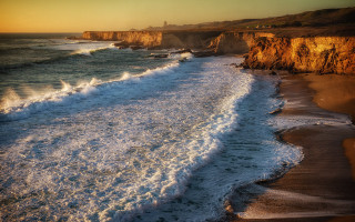 Beach waves cliffs sunset person - left free wallpaper