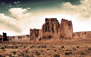 Desert rocks grass cloudy sky - a desert landscape free wallpaper