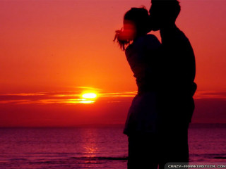 Couple kissing sunset beach silhouette - romantic free wallpaper