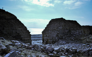 Stone buildings field water sky - widescreen free wallpaper
