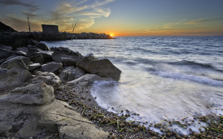 Sunset ocean rocky shore city - a sunset over the ocean free wallpaper