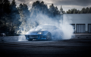 Blue car smoke trees night - a blue car free wallpaper