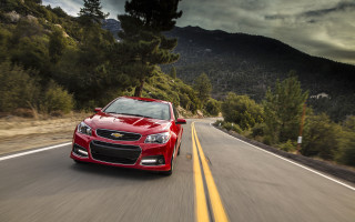 Red car mountains trees cloudy - a red car free wallpaper