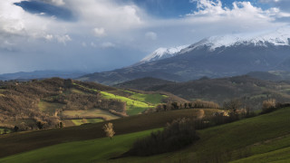 Mountain range snow capped green - mountain in the distance free wallpaper